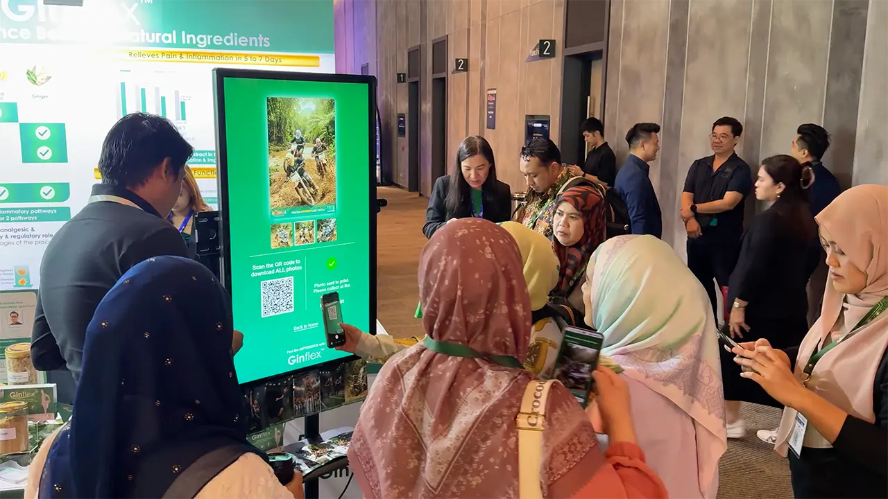 A 43-inch ARYA AI photo booth on a floor stand at a corporate event