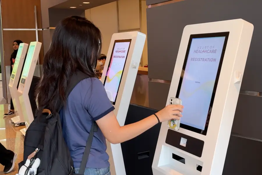 On-site registration kiosk scanning attendee QR codes